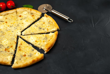 Delicious four cheese pizza on a concrete background. Top view of hot pizza. 