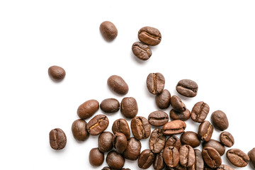 Roasted coffee beans isolated on white background. Close-up.