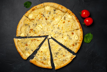 Delicious four cheese pizza on a concrete background. Top view of hot pizza. 