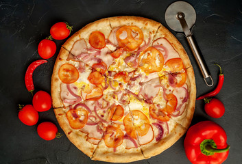 Delicious pizza on a concrete background. Top view of hot pizza.