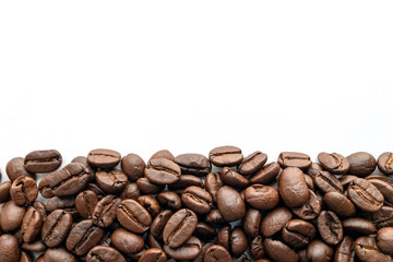 Roasted coffee beans on white background. Close-up.