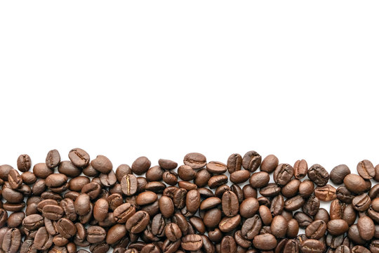 Roasted coffee beans on white background. Close-up.