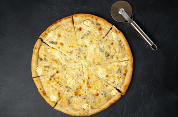 Delicious four cheese pizza on a concrete background. Top view of hot pizza. 