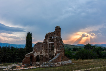 sunset over red church in bulgaria