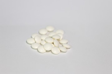 Closeup white supplement tablet 75 mg isolated with white background 