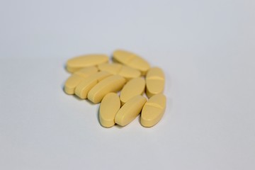 Closeup yellow supplement tablet 1000 mg isolated with white background 