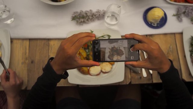man takes photo of his food 