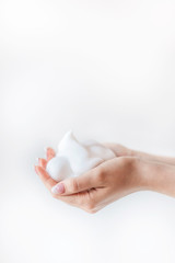 women's hands filled with white soft  foam