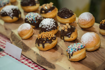 Pastries with icing Sugar and Chocolate Arranged on a Wooden Chopping Board