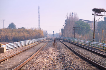 Fototapeta na wymiar View of two parallel tracks on the railway near a station