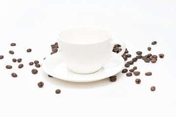 Coffee beans and white coffee cup isolated on a white background.
