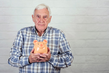 senior man with a piggybank