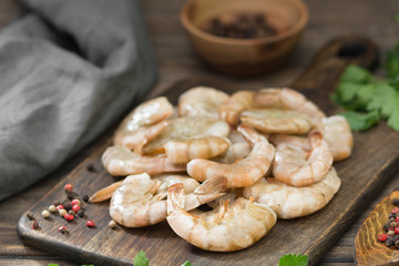 Raw tiger prawns on wooden Board on wooden background. Rustic style