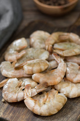 Raw tiger prawns on wooden Board on wooden background. Rustic style