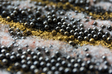 Layered blur sand pattern. Marble style background. Black and gold powder defocused texture.