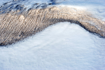 Melting snow, wet textured line, early spring, natural background, close up detail