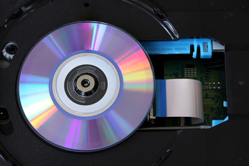 CD inside a DVD payer with  circuits, cables and boards - close up