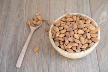 Almond nut on wood background.