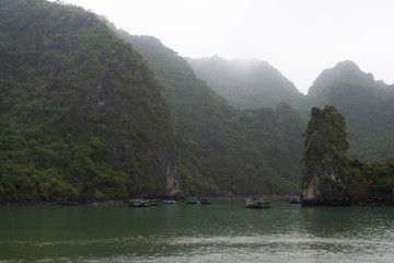 Halong Bay in mystical clouds. Mystical atmoshpere in the world famous halong bay.