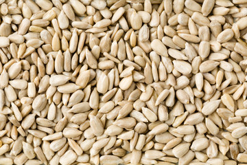 Top view of shelled sunflower seeds background texture