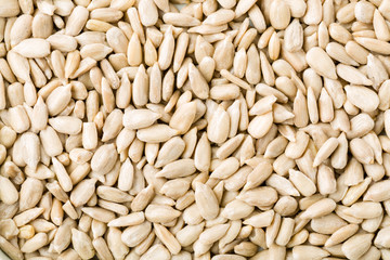 Top view of shelled sunflower seeds background texture