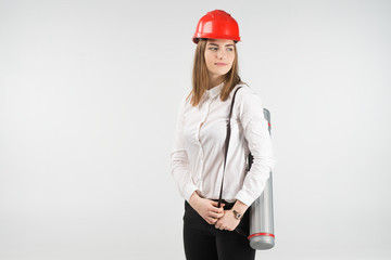 Woman   architect stands with a tube behind her back