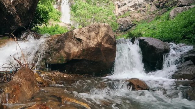 Small River Net Net water flows on stone in spring