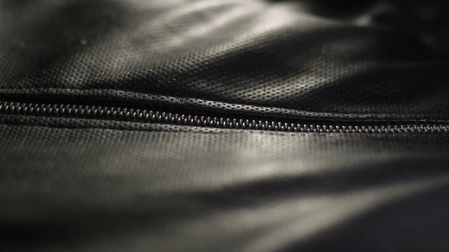 Repair of lightning on leather jacket in the studio close up