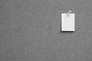 Horizontal cork board with many, sticky notes pinned