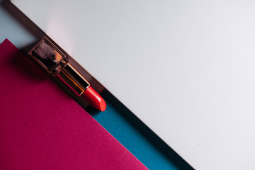 lipstick on modern colorful geometric background, cosmetics and beauty products
