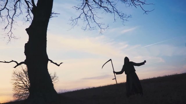 Grim Reaper sunset silhouette. concept of death. Soft focus
