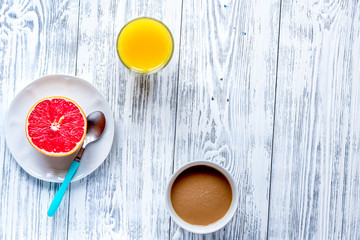 Breakfast concept with flowers on wooden background top view
