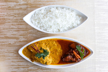 Katla Macher Jhal is a famous bengali fish curry served in two contrasting gravies-one sweetly pungent and the other spicy and tangy