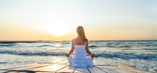 Woman meditating at the sea