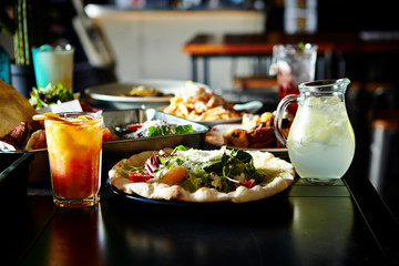 Salad pizza with drinks