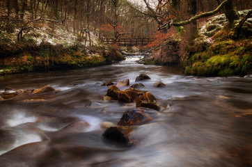 A light dusting of snow creating a Winter scene at the Afon Pyrddin river near Glynneath on the approach to a popular waterfall called Sgwd Gwladus or Lady Falls, South Wales, UK