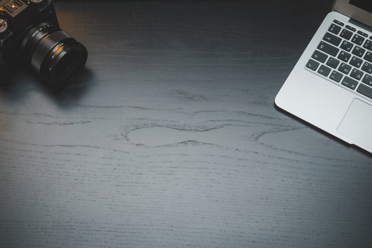 MacBook Ari and Fujifilm X-T3 camera on dark desk