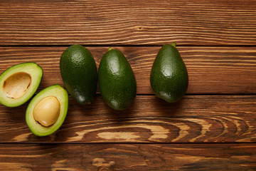 top view of avocados on wooden background