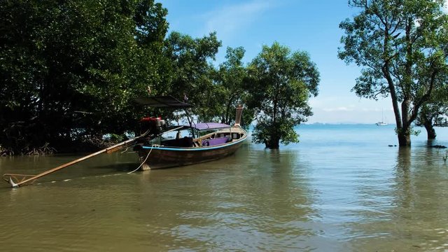 Serene scene in Krabi, Thailand. A boat gently rocking on the sea.