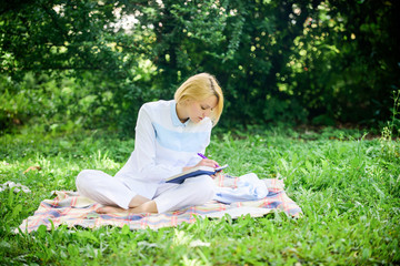 Naklejka na ściany i meble Business picnic concept. Steps to start freelancing business. Online business ideas concept. Woman with laptop or notebook sit on rug green grass meadow. Business lady freelancer work outdoors