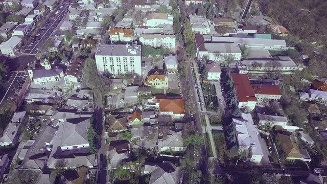 Aerial shot flying over European small city or suburb at sunset top view roofs of modern or historic houses streets and everyday life of small town shooting from helicopter amazing cityscape. Orhey, M