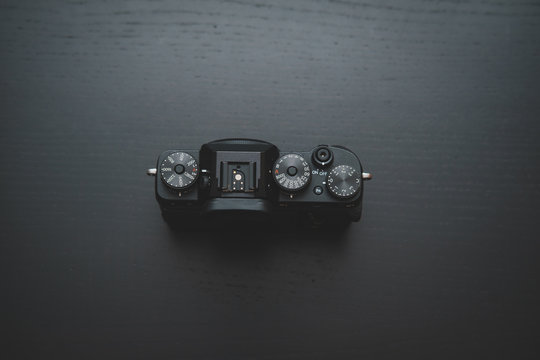 Fujifilm X-T3 camera on dark wooden desk