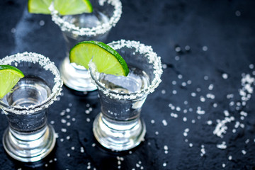 Set for tequila party with lime and salt on black background
