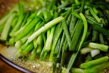 Cooking garlic chives in pot 