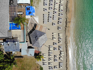 Aerial view of the Caribbean Sea with beach chairs at Reggae Beach near Christopher Harbor, Saint Kitts