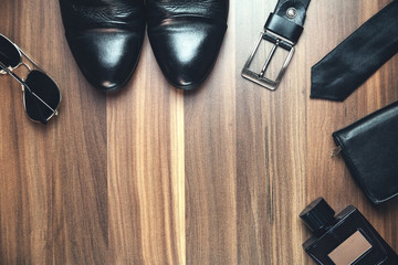 Men's accessories on the wood background.