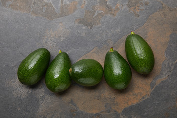 top view of avocados on grey background