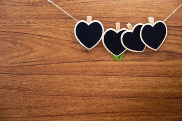  Heart shape chalkboards, blackboard clipped with Hemd rope on wooden background.