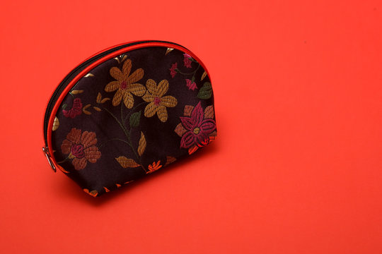 Coin Purse Shot On A Plain Isolated Red Background.