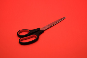 Typical scissor shot on a plain red isolated background.